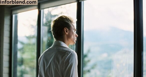 A reflective man by a sunrise window representing mindset change and purpose transformation.